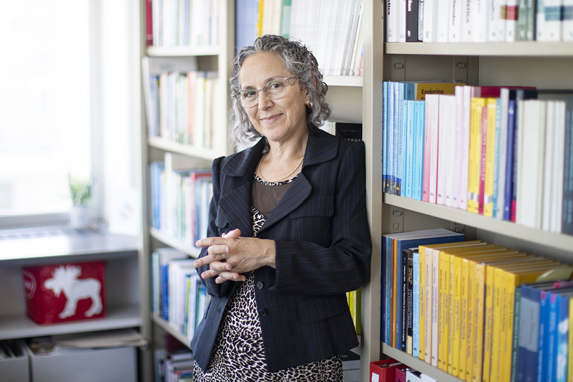 Photo of Sali Tagliamonte in front of book cases in her department office