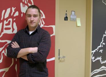 A portrait photo of Professor Ryan DeCaire, taken in the Centre for Indigenous Studies