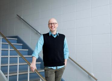 A photo of Nathan Sanders in a Sidney Smith Hall stairwell